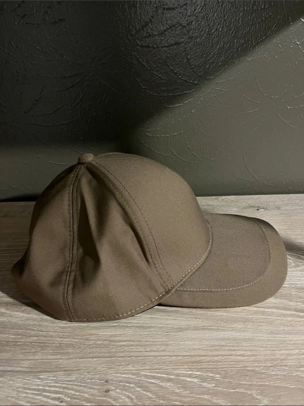 Brown Baseball Cap With Small Logo on Brim That Says “Sport Fashion”